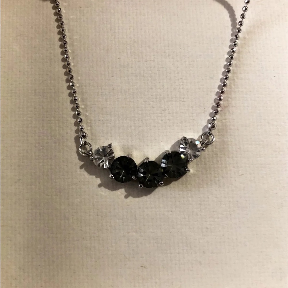 LEO branded silver necklace with five stones. 2 clear and 3 tinted bead-stones
